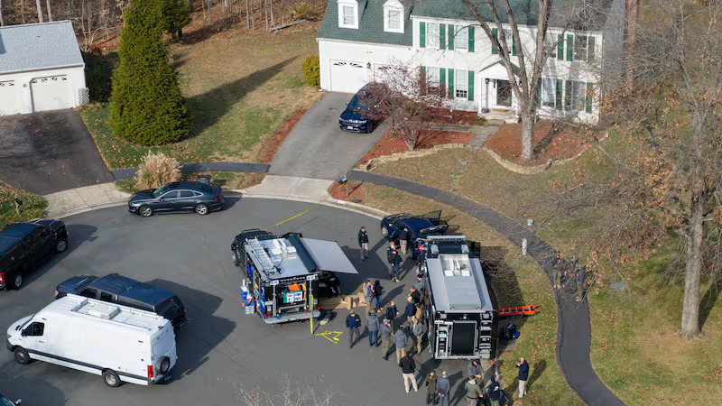FBI and law enforcement vehicles outside Brian Cole Jr.’s Virginia home during pipe bomb investigation