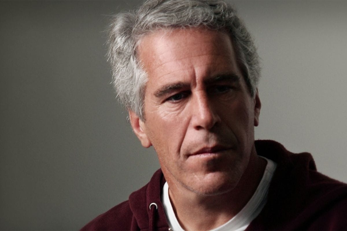 Stacks of newly released Epstein case files with blurred names and sealed folders