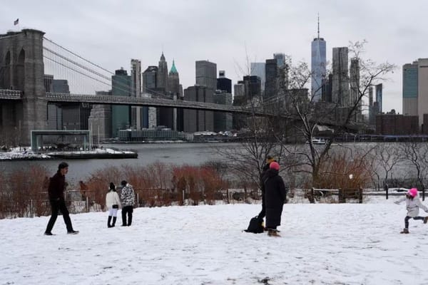 Snow-covered streets in New York City during major Northeast blizzard causing flight cancellations and travel disruptions