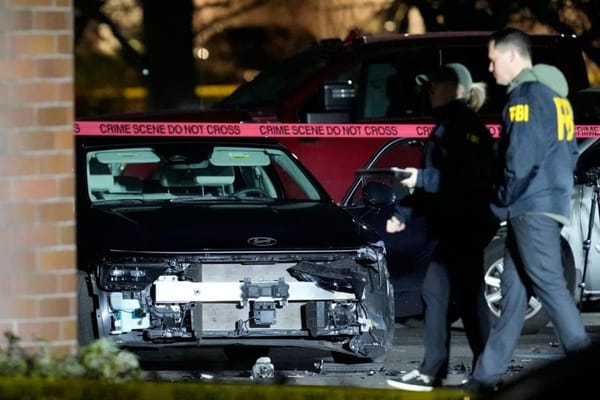 Federal agents investigate shooting scene in Portland where two people were injured.