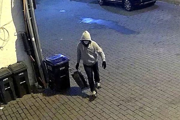 Surveillance image of a hooded suspect carrying a bag in Washington, D.C., before Jan. 6.